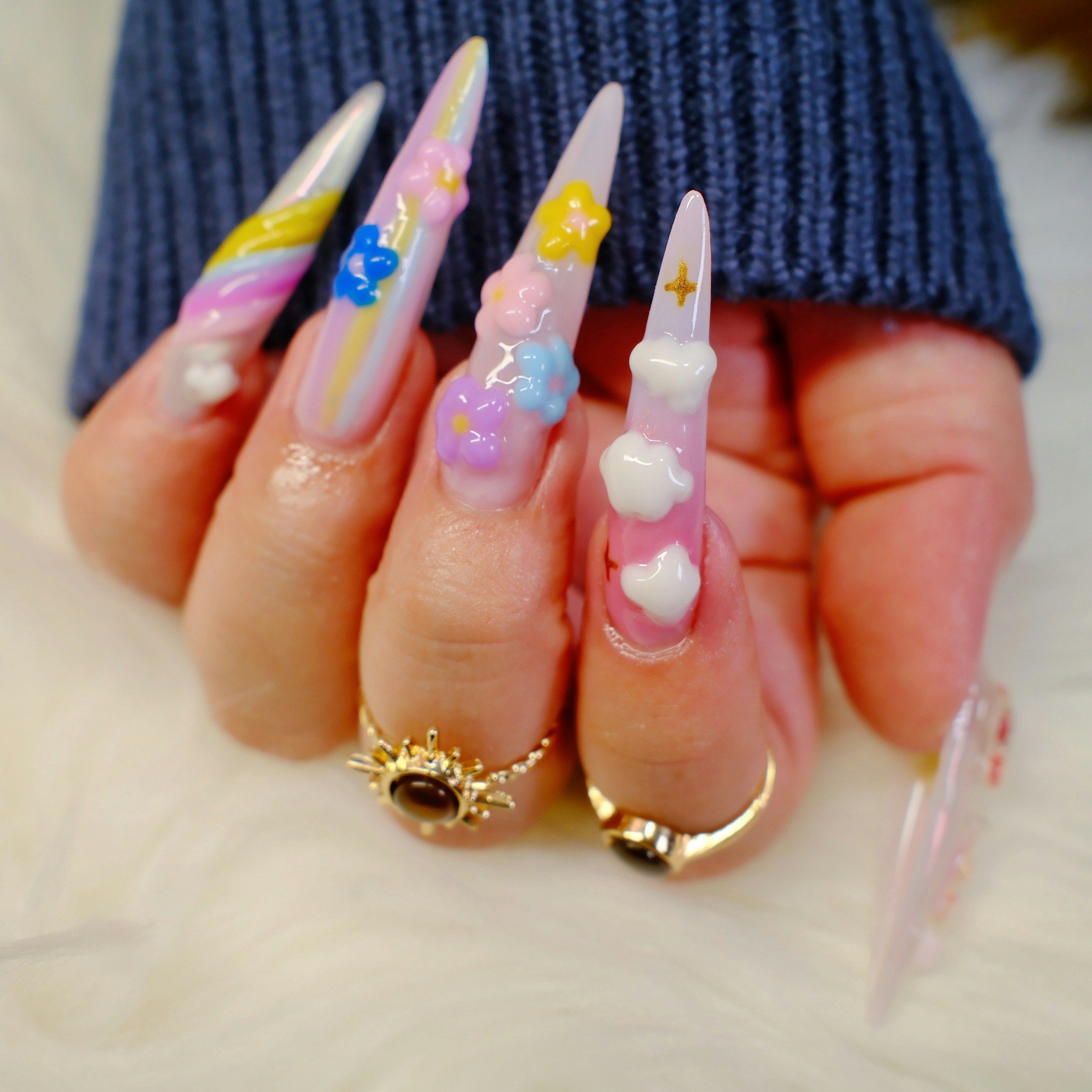 Gel-sculpted charms and pastel swirls on stilettos