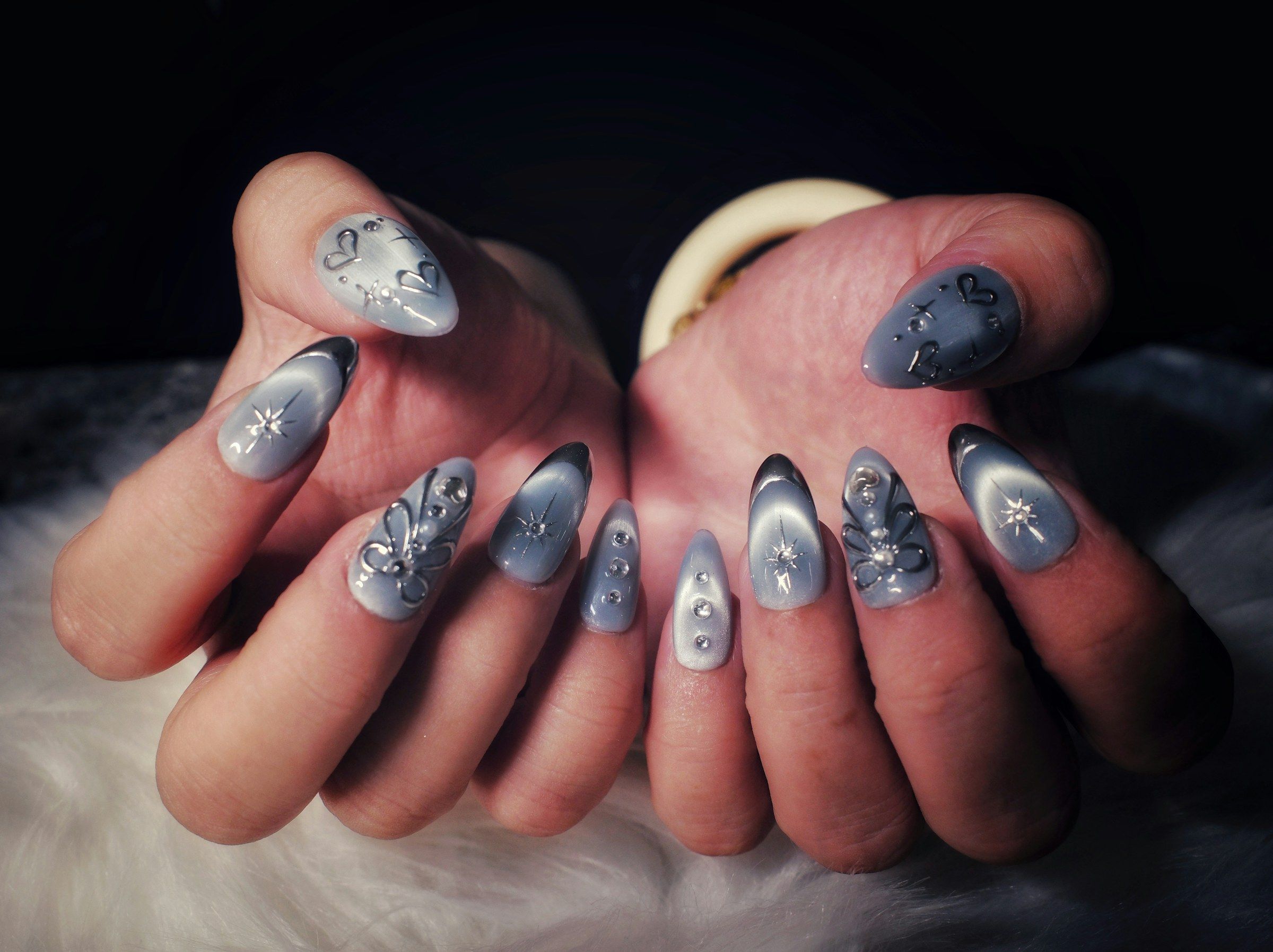 Magnetic cat-eye gel with chrome stars and crystals